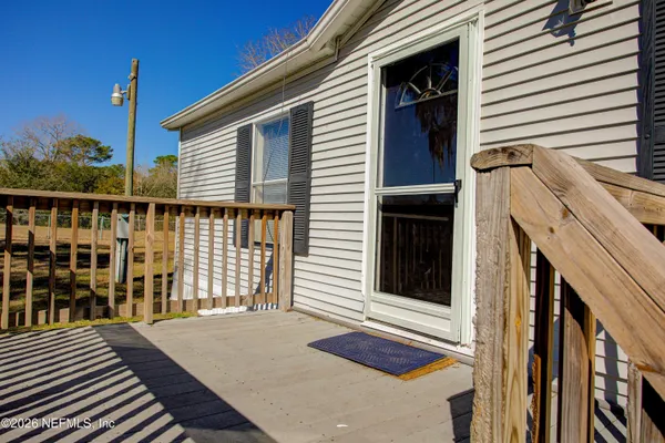 a view of a house with wooden fence