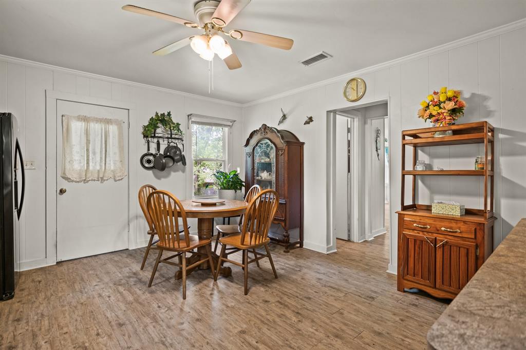 103 South Sun Camp Road White Oak, TX 75693 - Photo 18 of 40 a view of a dining room with furniture and wooden floor