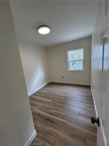 a view of kitchen with refrigerator and window