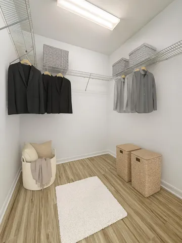 a bedroom with a bed and a wooden floor