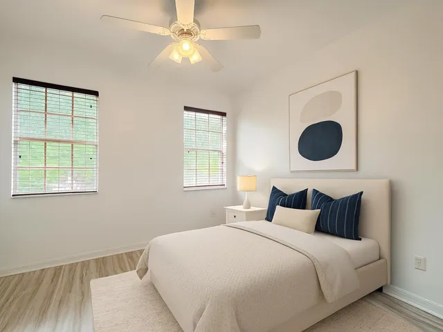 a bedroom with a large bed and a chandelier