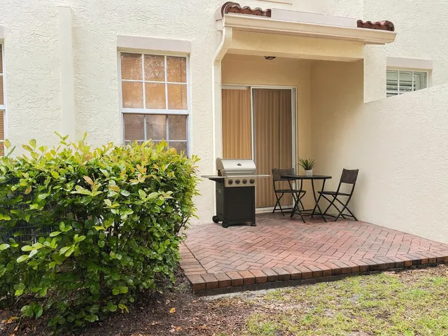 a view of a chair and table in the patio