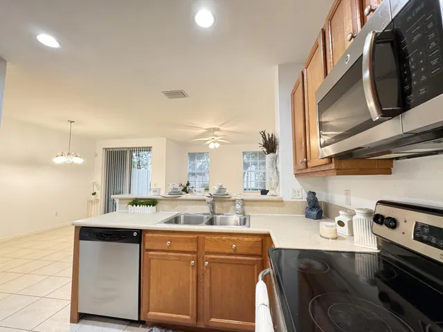a kitchen with stainless steel appliances granite countertop a sink stove and cabinets