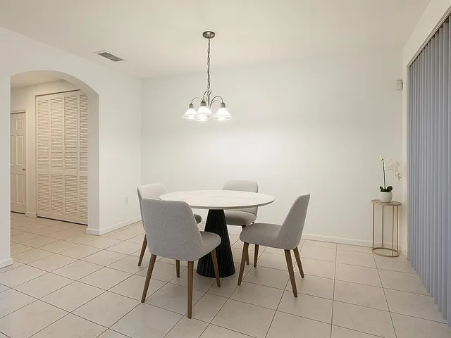 a view of a dining room with furniture and chandelier