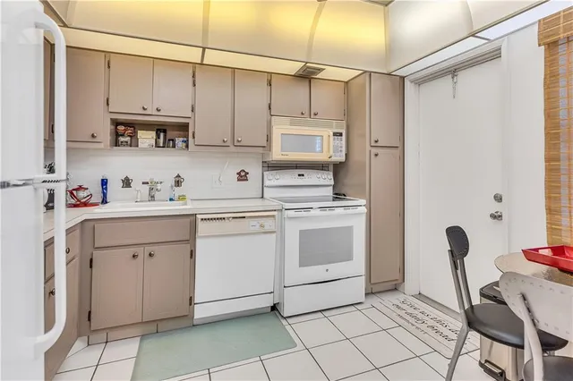 a kitchen with cabinets appliances and a sink