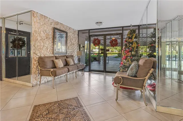 a living room with furniture a chandelier and glass door