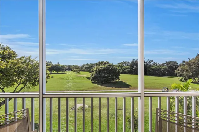 a view of a balcony next to a yard