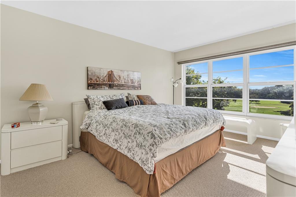 3100 North Palm Aire Drive, Unit 406 Pompano Beach, FL 33069 - Photo 3 of 16 a bedroom with a bed and a large window