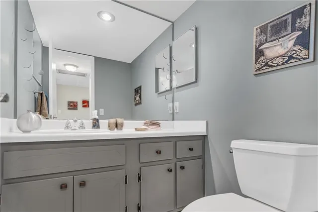 a bathroom with a toilet sink and mirror