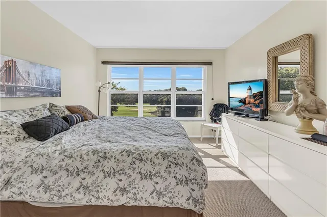 a bed sitting in a bedroom next to a window
