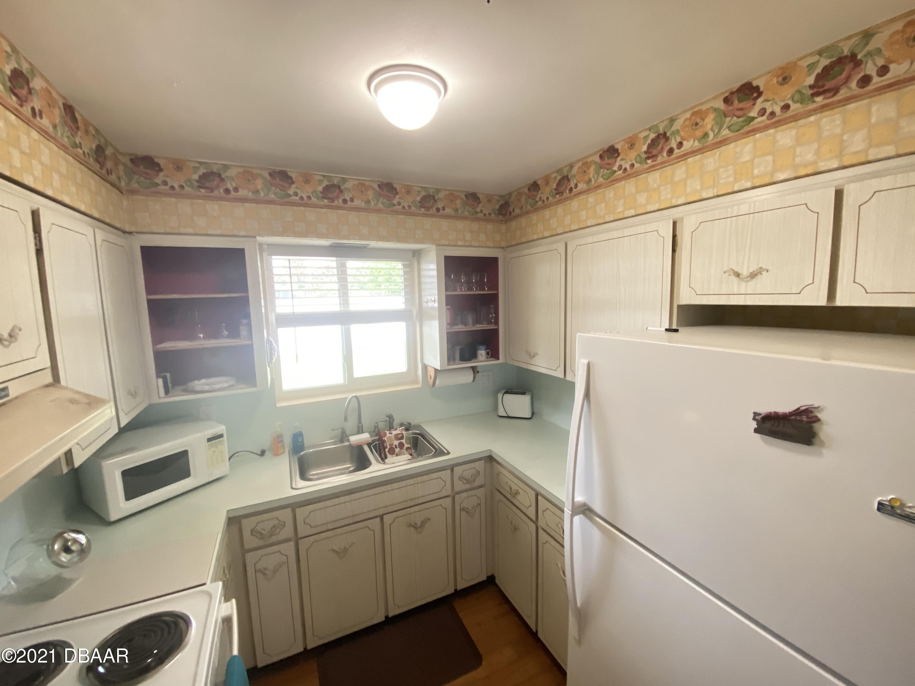 16 Silk Oaks Drive Ormond Beach, FL 32176 - Photo 11 of 37 a utility room with cabinets washer and dryer