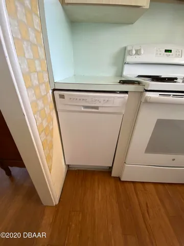 a stove top oven sitting inside of a kitchen