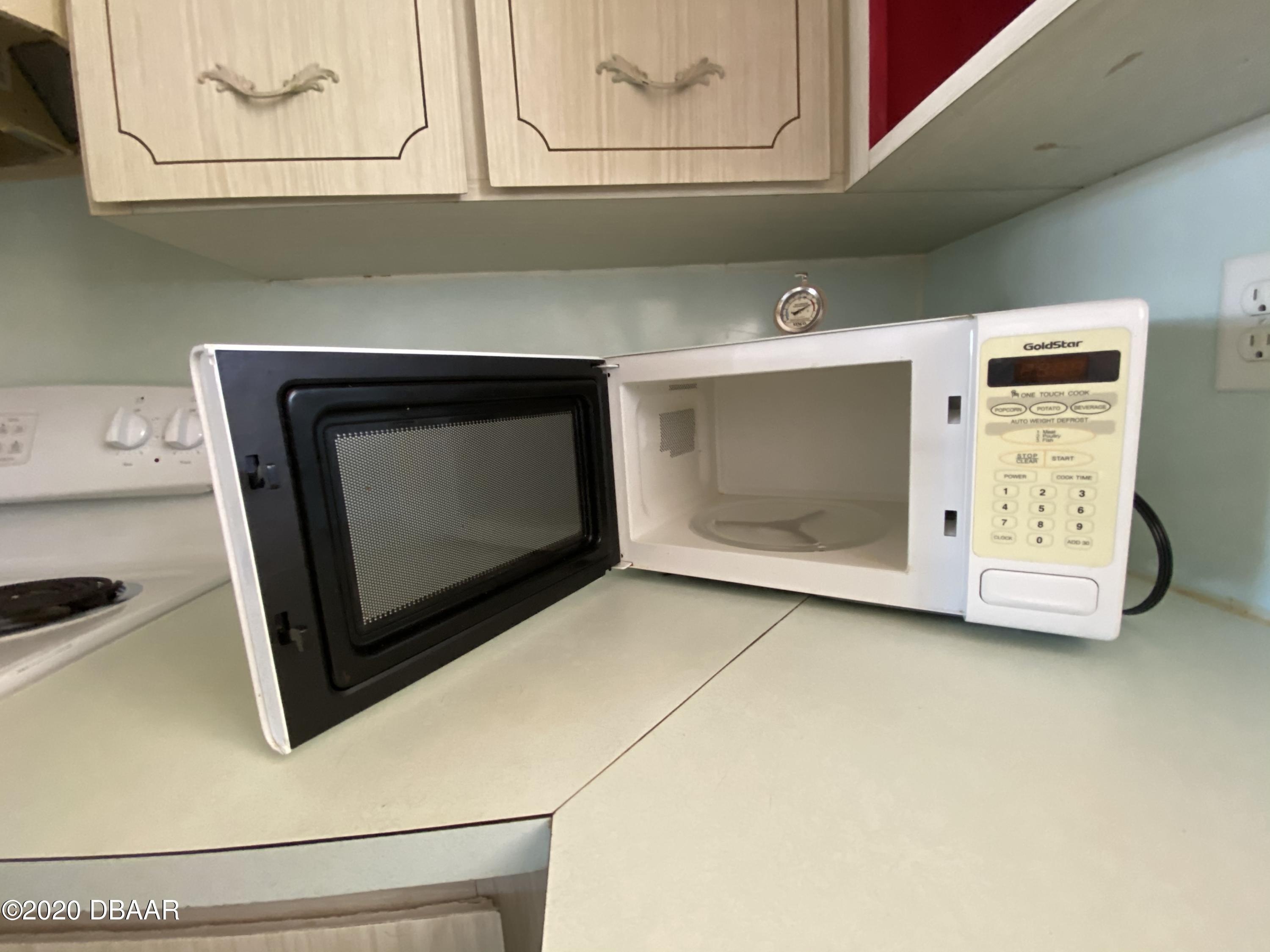 16 Silk Oaks Drive Ormond Beach, FL 32176 - Photo 16 of 37 a stove top oven sitting inside of a kitchen