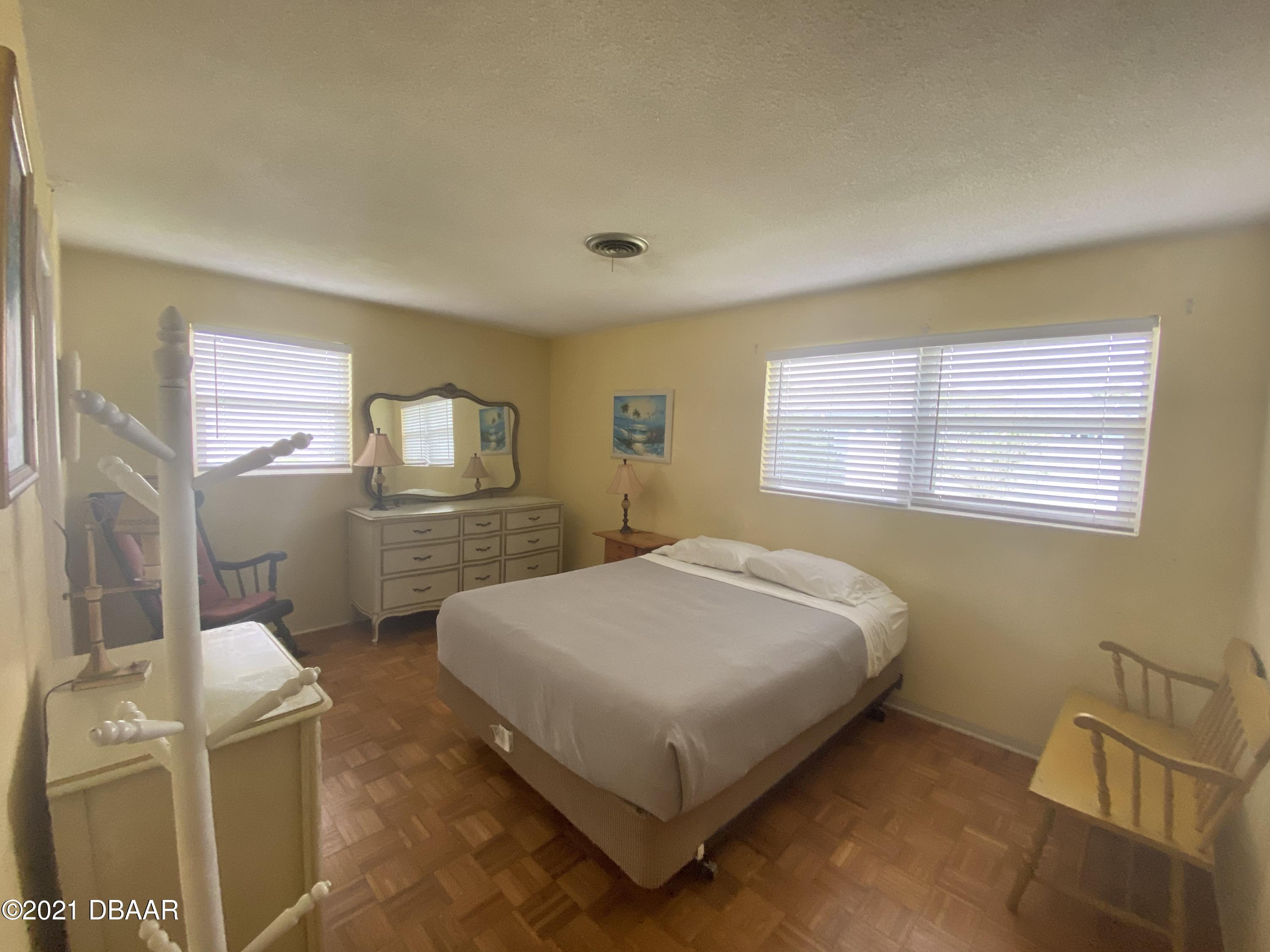 16 Silk Oaks Drive Ormond Beach, FL 32176 - Photo 21 of 37 a bedroom with a bed and window