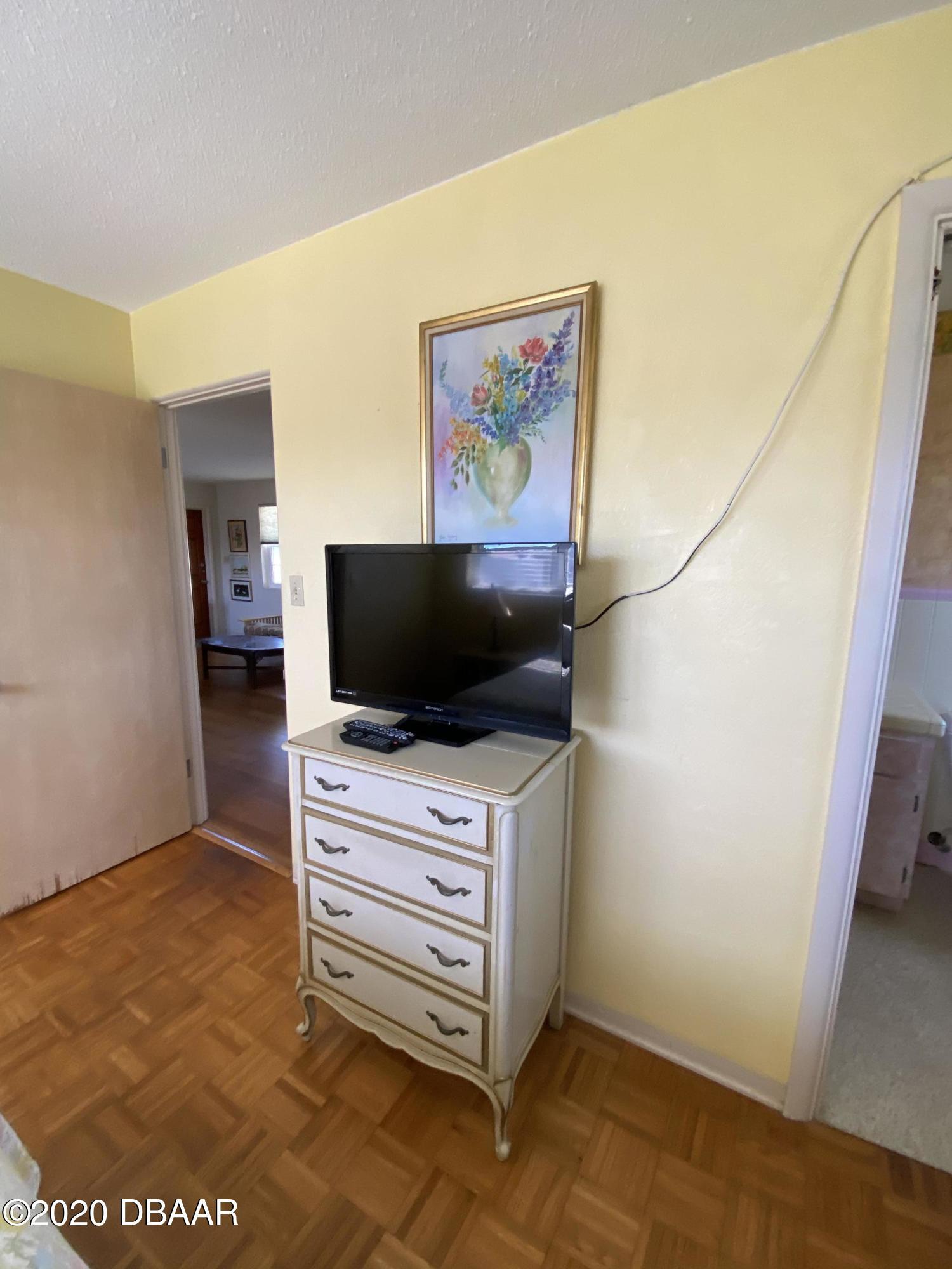 16 Silk Oaks Drive Ormond Beach, FL 32176 - Photo 23 of 37 a room with a flat screen tv and cabinets