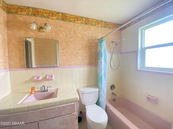 a bedroom with a bed and windows