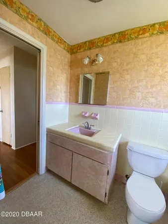 a bathroom with a toilet a sink and a mirror