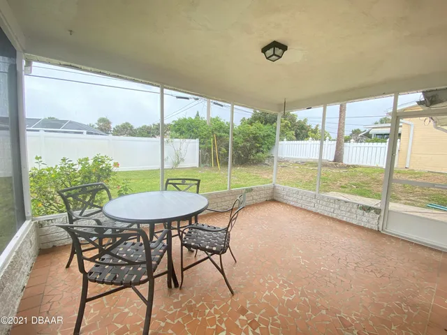 a view of a backyard with a large tree
