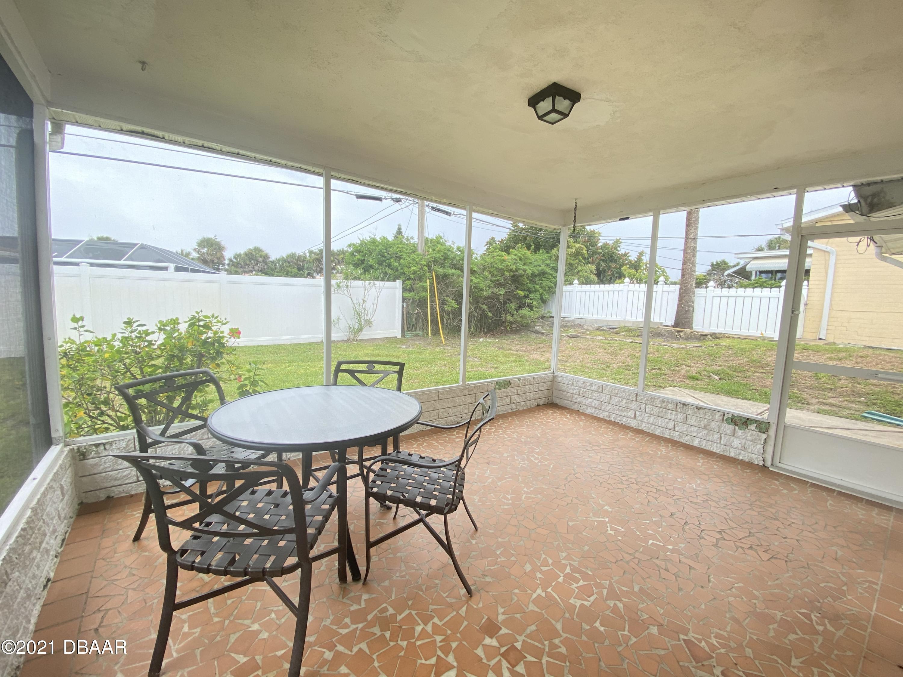 16 Silk Oaks Drive Ormond Beach, FL 32176 - Photo 32 of 37 a view of a porch with furniture and a yard