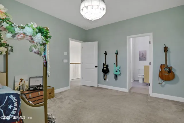 a view of a workspace with furniture and a ceiling fan