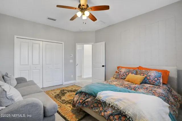 a bed sitting in a bedroom next to a window