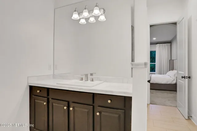 a spacious bedroom with a bed and a ceiling fan