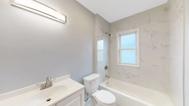 a bathroom with a sink toilet and bathtub