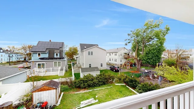 a view of houses with yard and outdoor seating
