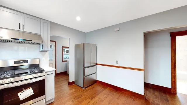 a kitchen with stainless steel appliances a stove a refrigerator and cabinets