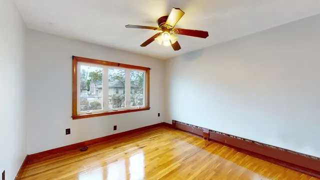 a view of room with window and ceiling fan