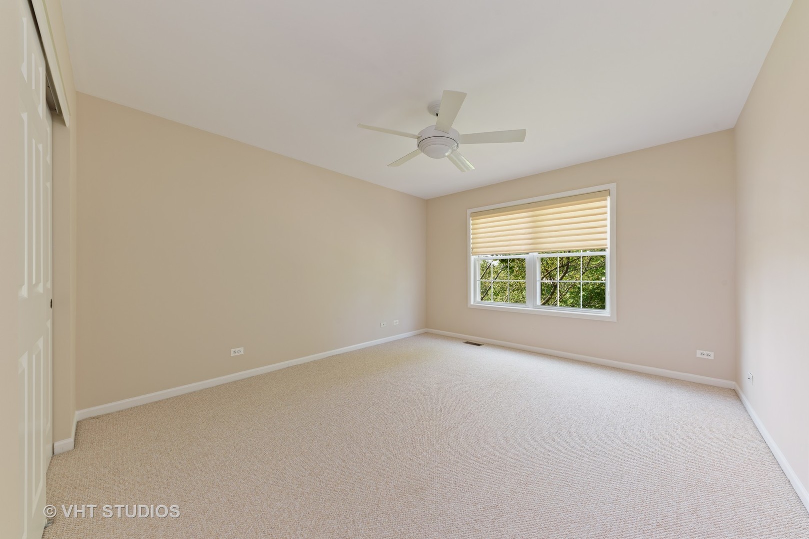 1743 Stanwich Road Vernon Hills, IL 60061 - Photo 13 of 20 an empty room with a window and a ceiling fan