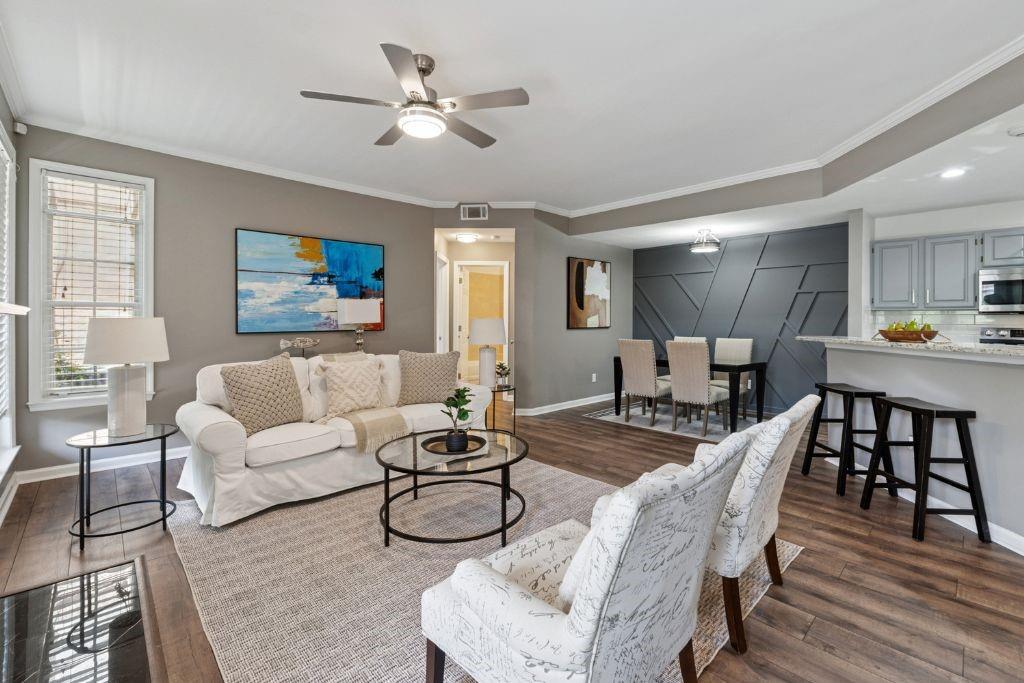 1037 McGill Park Avenue Northeast Atlanta, GA 30312 - Photo 1 of 46 a living room with furniture kitchen view and a dining table