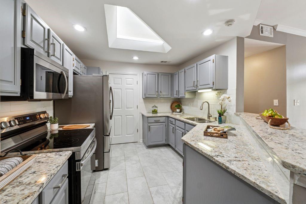 1037 McGill Park Avenue Northeast Atlanta, GA 30312 - Photo 16 of 46 a kitchen with a sink stove and refrigerator