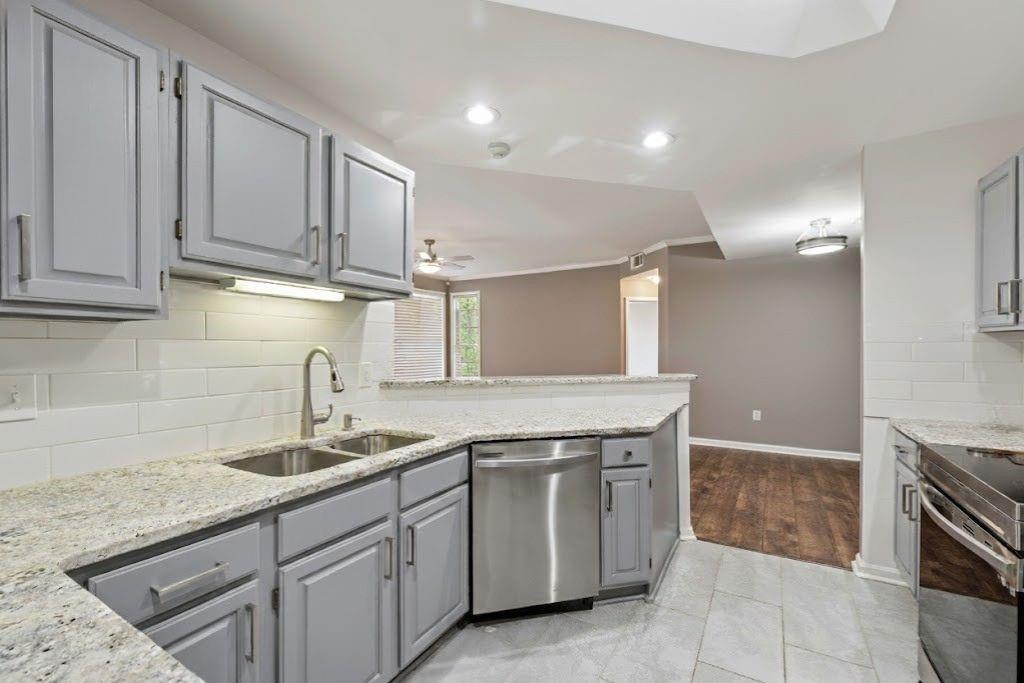 1037 McGill Park Avenue Northeast Atlanta, GA 30312 - Photo 19 of 46 a kitchen with a sink dishwasher and cabinets