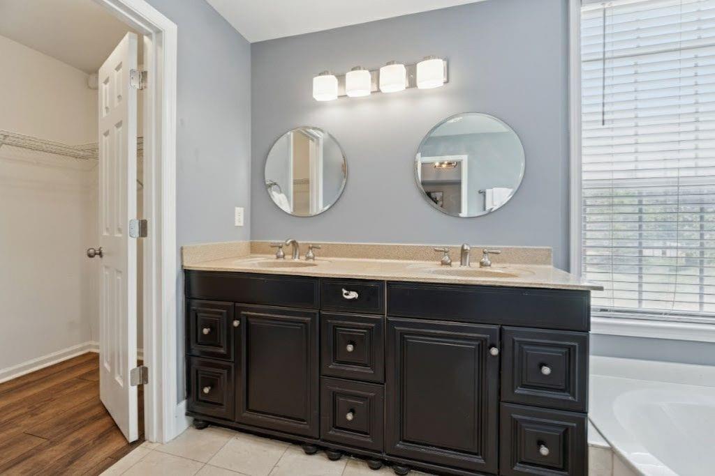 1037 McGill Park Avenue Northeast Atlanta, GA 30312 - Photo 26 of 46 a bathroom with a double vanity sink and a mirror