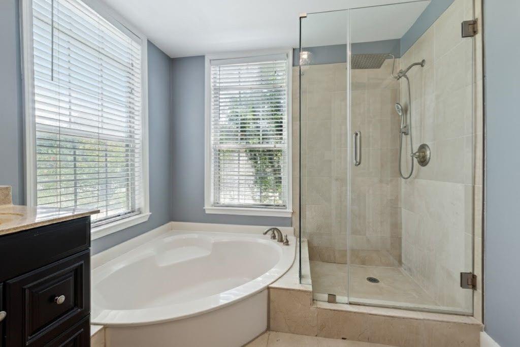 1037 McGill Park Avenue Northeast Atlanta, GA 30312 - Photo 30 of 46 a white bath tub sitting next to a shower