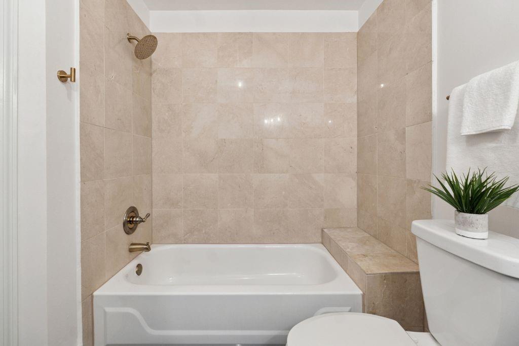 1037 McGill Park Avenue Northeast Atlanta, GA 30312 - Photo 31 of 46 a bathroom with a sink a toilet a bathtub and shower