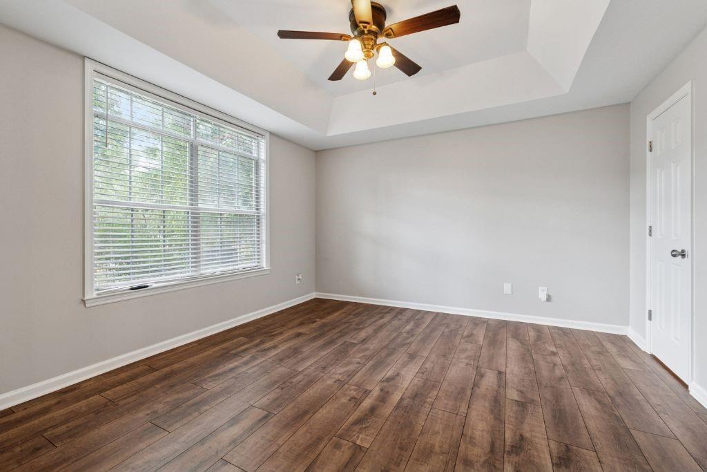 1037 McGill Park Avenue Northeast Atlanta, GA 30312 - Photo 37 of 46 a view of an empty room with wooden floor and a window