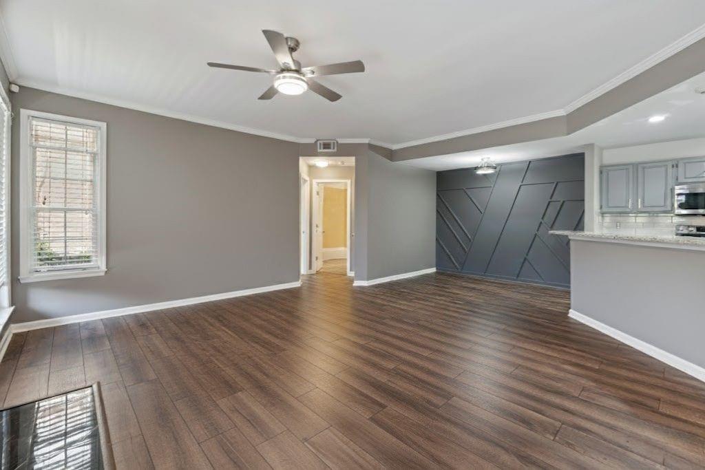 1037 McGill Park Avenue Northeast Atlanta, GA 30312 - Photo 9 of 46 a view of an empty room with wooden floor and a window