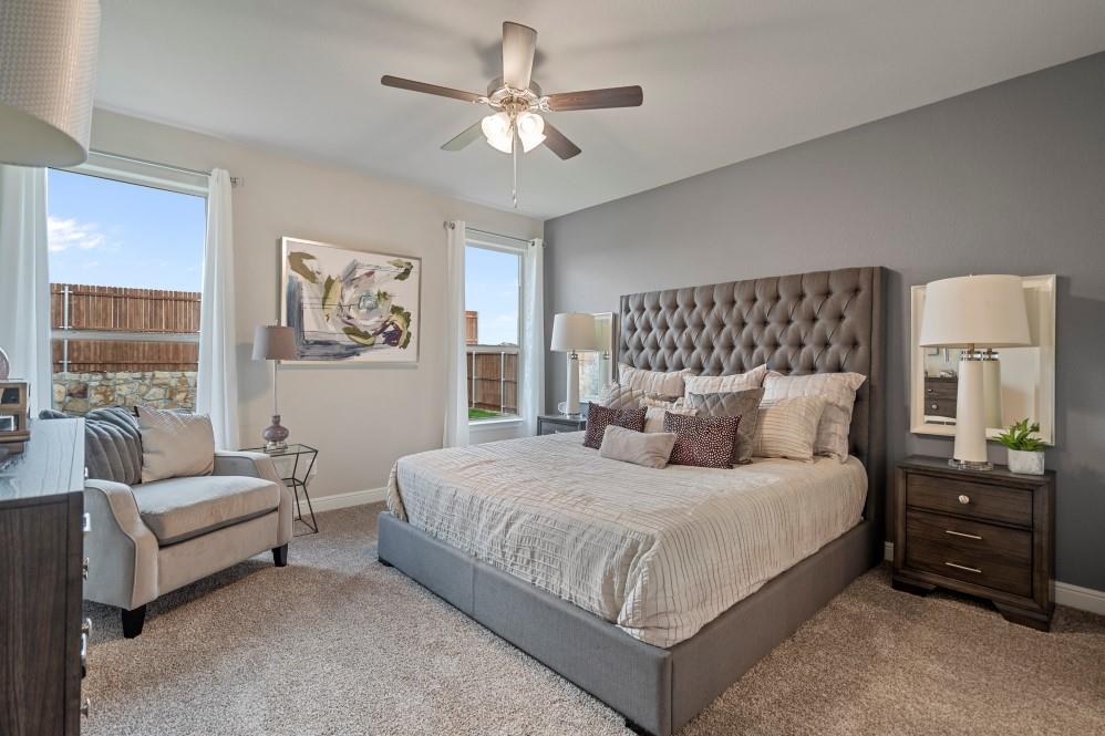 105 Ringtail Drive Rhome, TX 76078 - Photo 17 of 40 a bedroom with a large bed and a couch