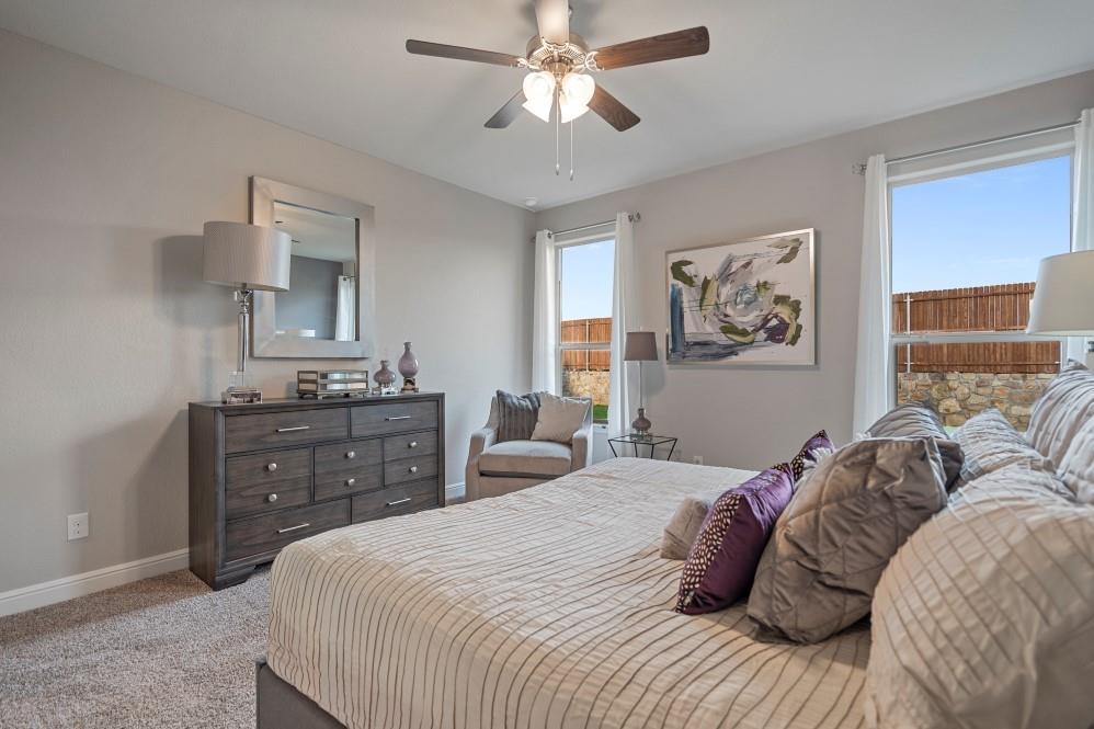 105 Ringtail Drive Rhome, TX 76078 - Photo 19 of 40 a bedroom with a bed and wooden floor