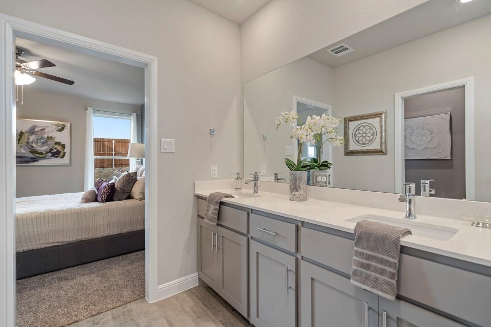 105 Ringtail Drive Rhome, TX 76078 - Photo 20 of 40 a en suite bathroom with a double vanity sink and mirror