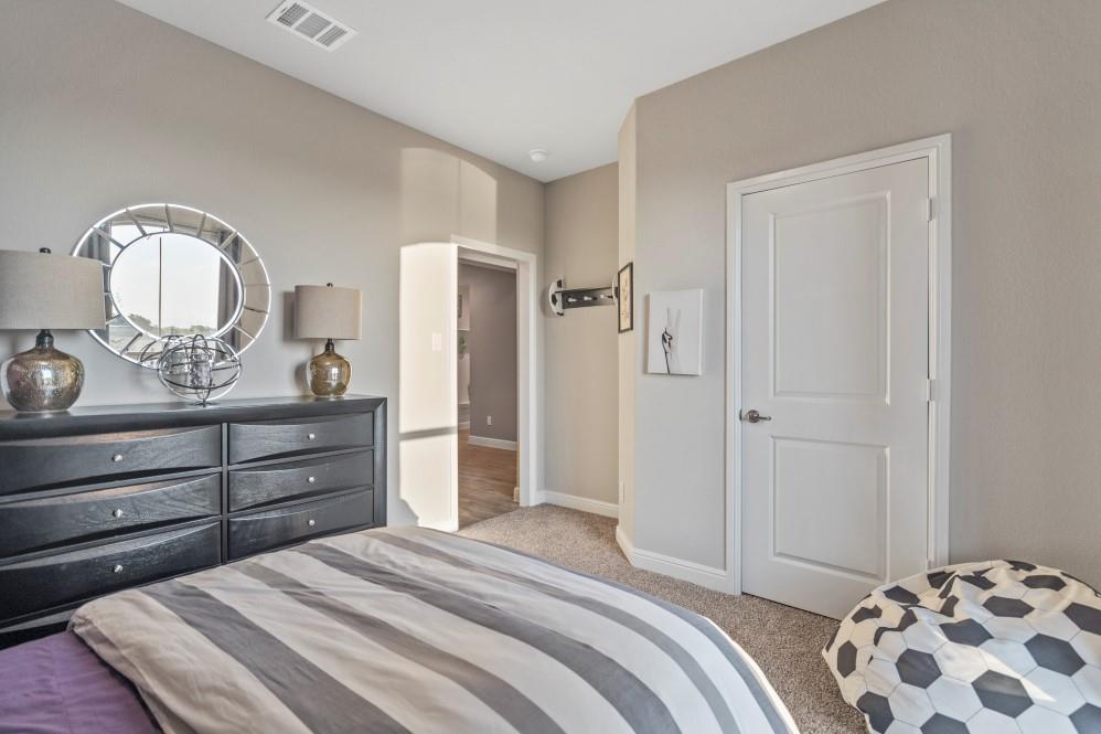 105 Ringtail Drive Rhome, TX 76078 - Photo 24 of 40 a bedroom with a bed and a dresser