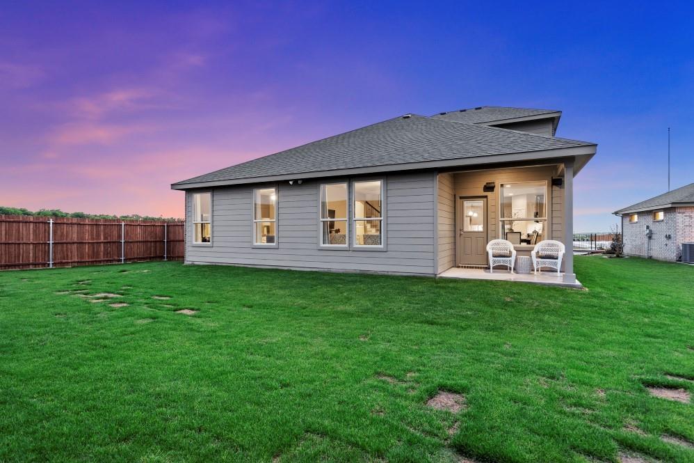 105 Ringtail Drive Rhome, TX 76078 - Photo 39 of 40 a backyard of a house with lots of green space