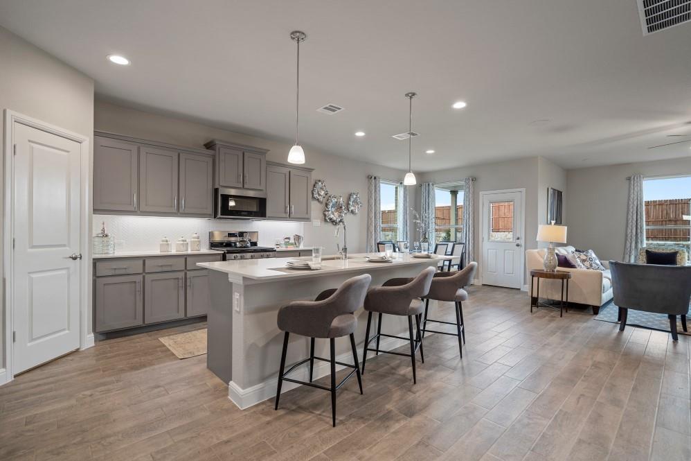 105 Ringtail Drive Rhome, TX 76078 - Photo 6 of 40 a kitchen with a sink cabinets and wooden floor