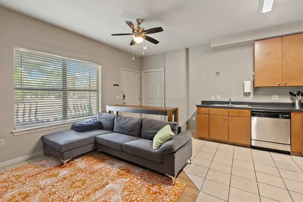 a living room with furniture and kitchen view