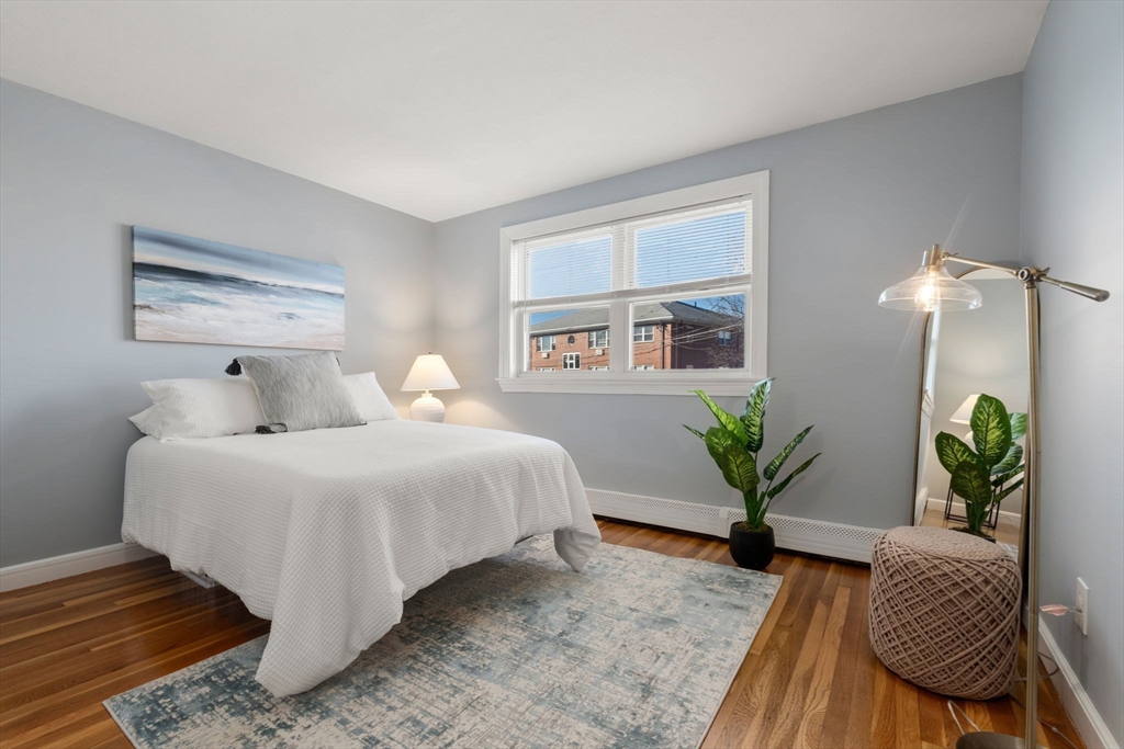 32 Whitman Road, Unit 14 Waltham, MA 02453 - Photo 12 of 20 a bedroom with bed and wooden floor