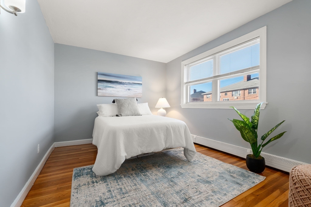 32 Whitman Road, Unit 14 Waltham, MA 02453 - Photo 13 of 20 a bedroom with a bed and a potted plant