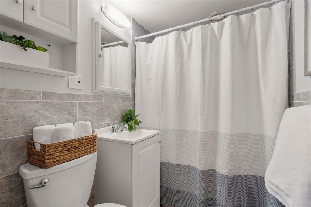 32 Whitman Road, Unit 14 Waltham, MA 02453 - Photo 14 of 20 a bathroom with a toilet and shower