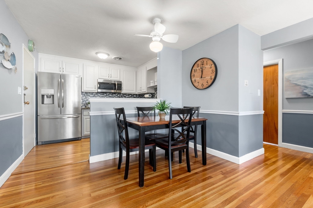 32 Whitman Road, Unit 14 Waltham, MA 02453 - Photo 5 of 20 a view of a dining room with furniture a rug and wooden floor